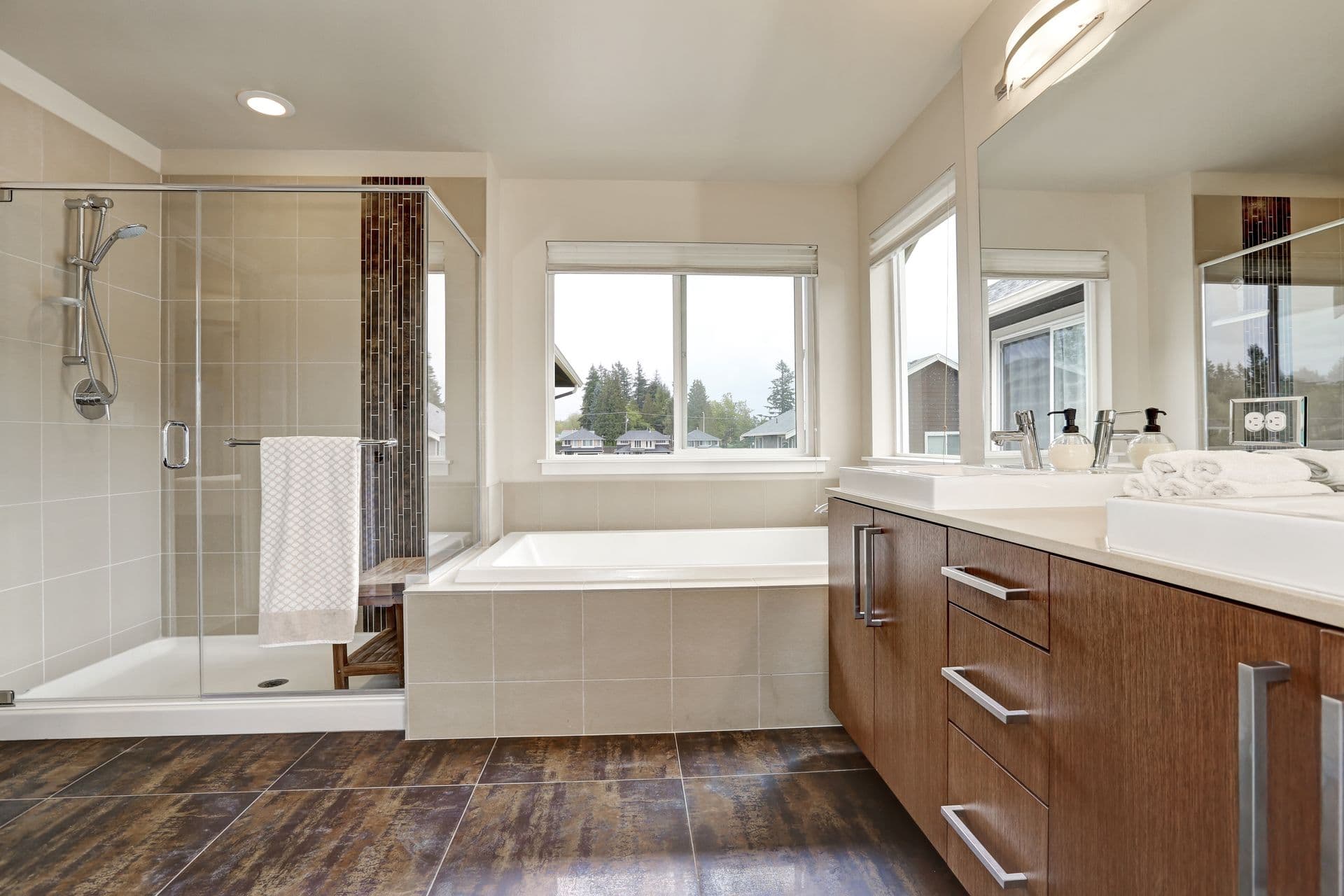 Various residential glass products in a bathroom - shower enclosure, mirror, and window